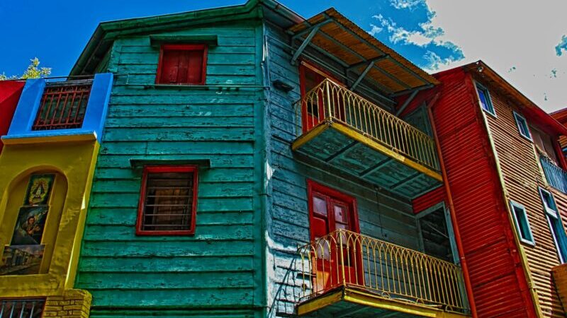 red and white wooden house under blue sky